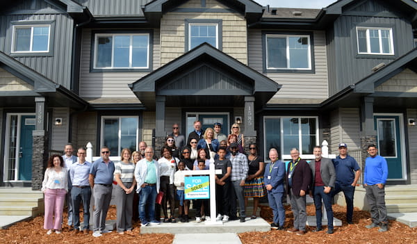 Pacesetter Homes Edmonton team and Habitat for Humanity representatives presenting a new home to a local family in 2025.
